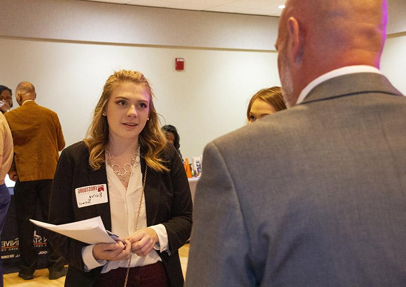 female students talks to rep durign career fair