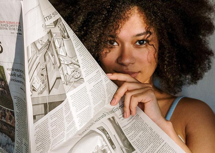 student reading newspaper