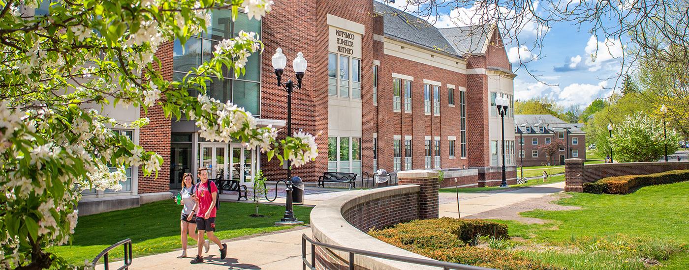 A Frostburg State Student Admissions Ambassador chats with parents and students while walking and giving a tour of campus